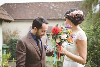 coiffure de mariée sur le côté avec chignon bouclé et fleurs décoratives