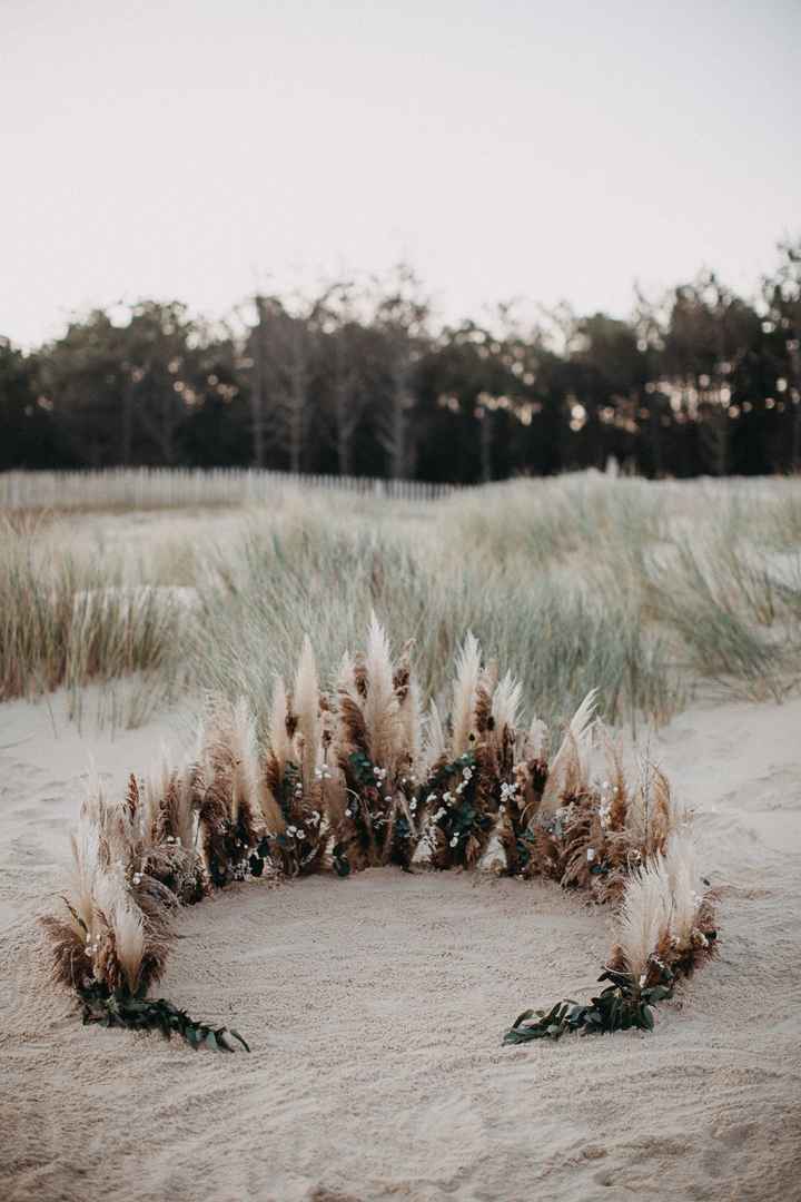 Arche avec des fleurs et plumes sur la plage