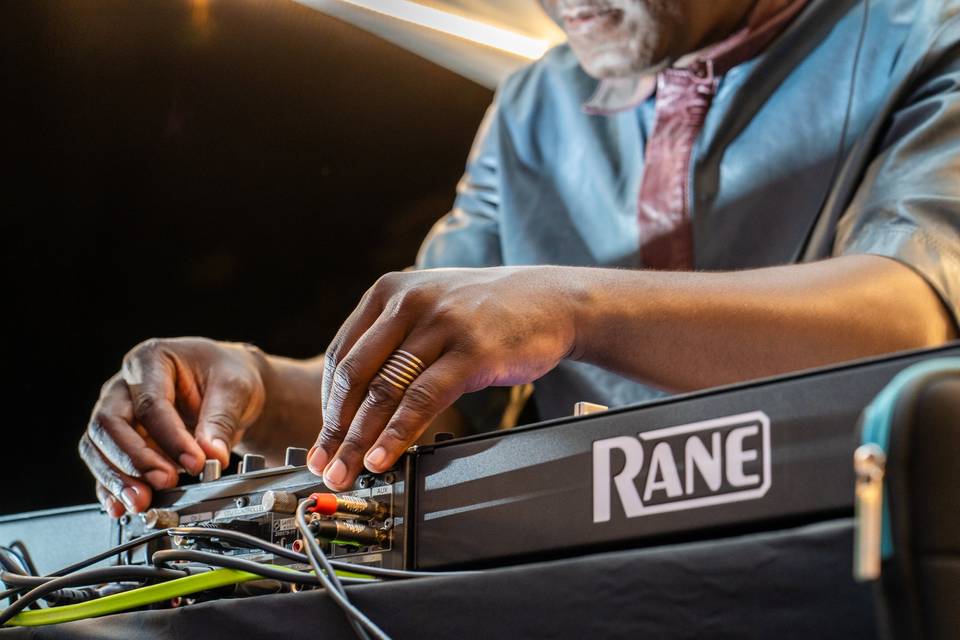 Détail des mains du DJ sur la table de mixage