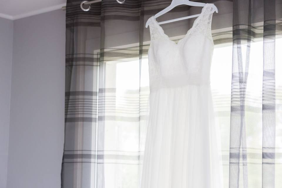 Robe de mariée suspendue devant la fenêtre