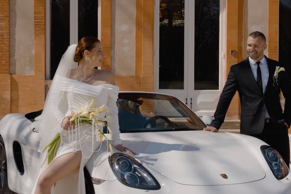 Mariés avec voiture luxueuse